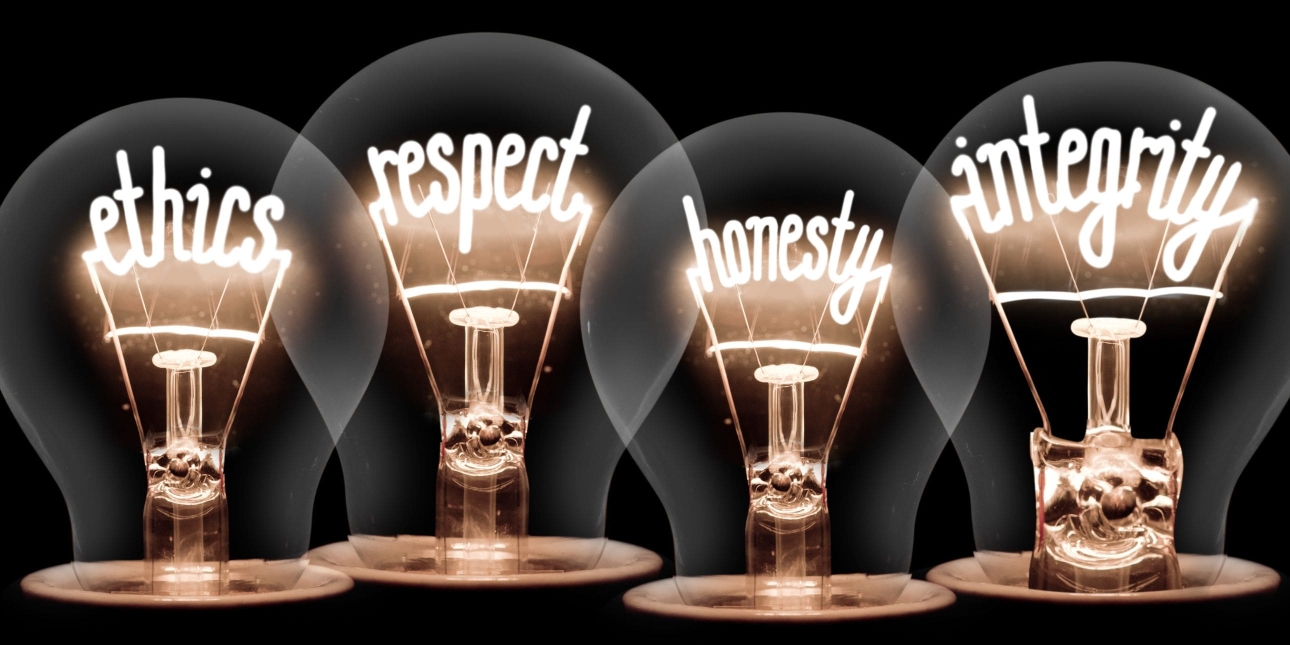 Illustration of four lightbulbs with the words ethics, respect, honesty and integrity spelt out in the filaments